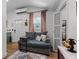 Living room showcasing a comfortable couch and a view of the exterior and interior at 407 E Jersey St, Orlando, FL 32806
