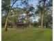 Serene picnic area featuring a covered pavilion with tables surrounded by lush green grass and mature trees at 407 E Jersey St, Orlando, FL 32806