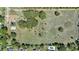 Clear aerial shot showing a parcel of land, trees, and nearby residences, illustrating a blend of natural and residential space at 4550 Chandler Rd, Apopka, FL 32712