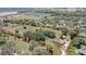 Expansive aerial view of a property with a large lot, framed by mature trees and neighboring homes at 4550 Chandler Rd, Apopka, FL 32712