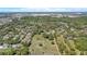 Wide aerial shot showcasing a neighborhood amidst dense trees, revealing houses with varying roof styles and ample yard space at 4550 Chandler Rd, Apopka, FL 32712