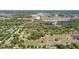 Aerial view featuring a mix of residential homes, commercial properties, and a large greenhouse complex in a sunny, sprawling landscape at 4550 Chandler Rd, Apopka, FL 32712