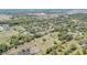Expansive aerial view of a residential area surrounded by lush greenery and community amenities under a clear, sunny sky at 4550 Chandler Rd, Apopka, FL 32712