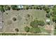 Expansive aerial view showcases a large property with mature trees, grassy areas, and distant neighboring homes at 4550 Chandler Rd, Apopka, FL 32712