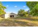 Exterior view of a barn on a grassy lot with trees at 4550 Chandler Rd, Apopka, FL 32712