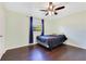 Cozy bedroom features a ceiling fan and a window providing natural light at 4550 Chandler Rd, Apopka, FL 32712