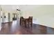 Cozy dining area with hardwood floors, ceiling fan, and stainless steel refrigerator at 4550 Chandler Rd, Apopka, FL 32712