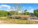 Scenic view of the home and its surrounding landscape, including mature trees and a spacious yard at 4550 Chandler Rd, Apopka, FL 32712