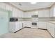 Bright kitchen features white cabinetry, tile floors, modern appliances and granite countertops at 4550 Chandler Rd, Apopka, FL 32712