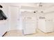 Functional laundry room with a washer, dryer, shelving, and tile flooring at 4550 Chandler Rd, Apopka, FL 32712