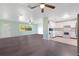 Open-concept living space with hardwood floors, a ceiling fan, and ample natural light at 4550 Chandler Rd, Apopka, FL 32712