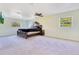 Large main bedroom with carpet floors, a ceiling fan, a television, and two windows at 4550 Chandler Rd, Apopka, FL 32712