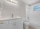 Bright bathroom with white vanity, modern fixtures, and tub with tile surround at 4751 Deer Run Rd, St Cloud, FL 34772