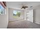 Bright bedroom features neutral paint, ceiling fan, carpet and large window at 4751 Deer Run Rd, St Cloud, FL 34772