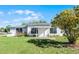 Charming single-story home featuring a white brick facade, well-manicured lawn, and inviting front entrance at 4751 Deer Run Rd, St Cloud, FL 34772