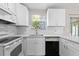 Beautiful updated kitchen with white cabinets, quartz countertop, and stainless appliances at 4751 Deer Run Rd, St Cloud, FL 34772