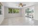 Sunny living room with tile floors and sliding glass doors to patio at 4751 Deer Run Rd, St Cloud, FL 34772
