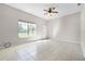 Spacious living room features ceramic tile floors, fresh paint, and large window at 4751 Deer Run Rd, St Cloud, FL 34772