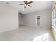 Bright living room features ceramic tile floors, fresh paint, and a ceiling fan at 4751 Deer Run Rd, St Cloud, FL 34772