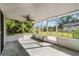 Covered and screened in porch area with ceiling fan and backyard views at 4751 Deer Run Rd, St Cloud, FL 34772