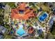 Aerial view showcasing community amenities, including a pool, playground, and clubhouse amidst tropical landscaping at 4761 Ormond Beach Way, Kissimmee, FL 34746