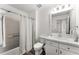 Bathroom with a tub-shower combo, white vanity, and wood-look flooring, offering a clean aesthetic at 4761 Ormond Beach Way, Kissimmee, FL 34746