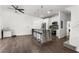 Bright kitchen with white cabinetry, stainless appliances, a large island and wood flooring at 4761 Ormond Beach Way, Kissimmee, FL 34746