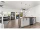 Open-concept kitchen featuring a marble island, modern appliances, and dark wood flooring at 4761 Ormond Beach Way, Kissimmee, FL 34746