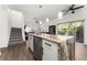 Kitchen island with marble countertop offers seating and transitions to the open living room at 4761 Ormond Beach Way, Kissimmee, FL 34746
