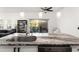 Close up of kitchen island with granite countertop, stainless sink and view to lanai/pool at 4761 Ormond Beach Way, Kissimmee, FL 34746