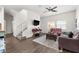 Bright living room with modern flooring, ceiling fan, and comfortable seating arrangement at 4761 Ormond Beach Way, Kissimmee, FL 34746