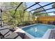 Inviting screened-in pool area with lounge chairs and ample space for outdoor enjoyment at 4761 Ormond Beach Way, Kissimmee, FL 34746