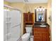 Bathroom featuring a shower, toilet, and vanity with wood cabinets at 4772 Vero Beach Pl, Kissimmee, FL 34746