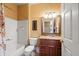 Cozy bathroom with vanity, framed mirror, decorative shower curtain, and tiled floor at 4772 Vero Beach Pl, Kissimmee, FL 34746