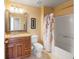 Cozy bathroom with vanity, framed mirror, decorative shower curtain, and tiled floor at 4772 Vero Beach Pl, Kissimmee, FL 34746