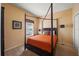 Spacious bedroom features a four-poster bed, plush carpeting, and a bright window with natural light at 4772 Vero Beach Pl, Kissimmee, FL 34746