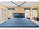 Bright bedroom features a bed with a large window, offering bright natural light, and a decorative mirror at 4772 Vero Beach Pl, Kissimmee, FL 34746
