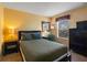 Cozy bedroom features a bed with a window, offering bright natural light with lamps on each side table at 4772 Vero Beach Pl, Kissimmee, FL 34746