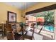 Bright dining area with glass table, stylish lighting, and screened patio view at 4772 Vero Beach Pl, Kissimmee, FL 34746