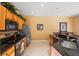 Bright kitchen featuring stainless steel appliances, ample countertop space, and warm wood cabinetry at 4772 Vero Beach Pl, Kissimmee, FL 34746