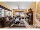 Spacious living room with neutral decor, large windows, and modern entertainment center at 4772 Vero Beach Pl, Kissimmee, FL 34746