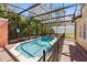 The screened-in pool is surrounded by trees, providing great privacy at 4772 Vero Beach Pl, Kissimmee, FL 34746