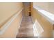 Stairway with carpeted steps and a white banister leading to the upper level at 4772 Vero Beach Pl, Kissimmee, FL 34746