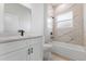 Bathroom features a sleek vanity and a shower-over-tub with marble-look tile at 4774 Sw 142Nd Place Rd, Ocala, FL 34473