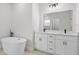 Bright bathroom offers double vanity, soaking tub, and modern fixtures at 4774 Sw 142Nd Place Rd, Ocala, FL 34473