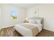 Bright bedroom featuring a cozy bed, neutral decor, and a large window offering natural light at 4774 Sw 142Nd Place Rd, Ocala, FL 34473