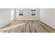 Bright room with wood-look floors and two windows overlooking a fenced yard at 4774 Sw 142Nd Place Rd, Ocala, FL 34473