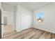 Bedroom with hardwood floors and a closet with bifold doors and a neighborhood view at 4774 Sw 142Nd Place Rd, Ocala, FL 34473