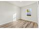 Bedroom with closet, wood floors, and bright light from a window view at 4774 Sw 142Nd Place Rd, Ocala, FL 34473