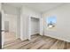 Bright bedroom with hardwood floors, closet, and a view of the neighborhood at 4774 Sw 142Nd Place Rd, Ocala, FL 34473